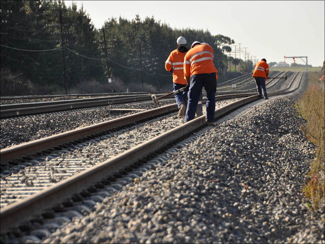 Track workers working on rail