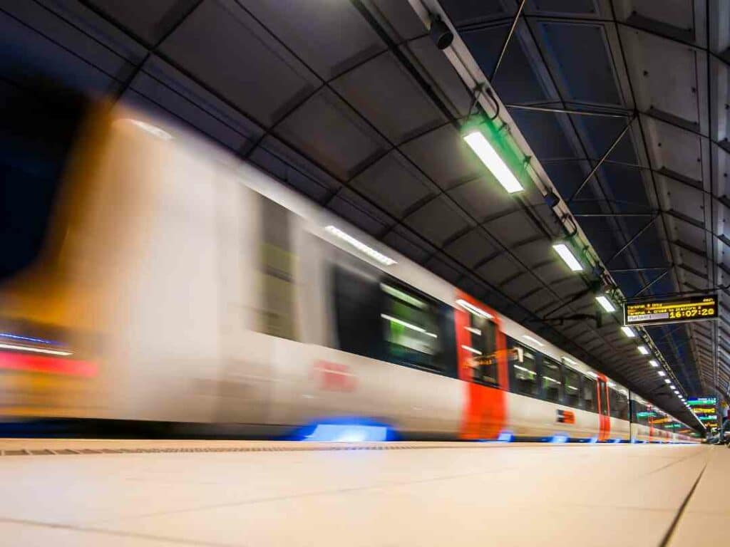 Train passing through a station at speed